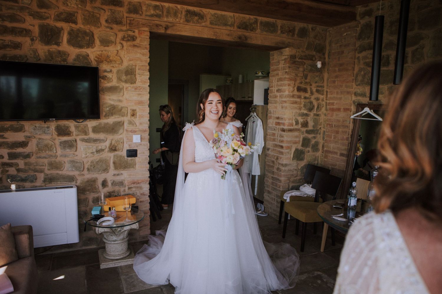 Bride showing her dress to family at Perugia Vecchia Relais photographed by Gianluca e Arianna Wedding Photographers in Umbria.