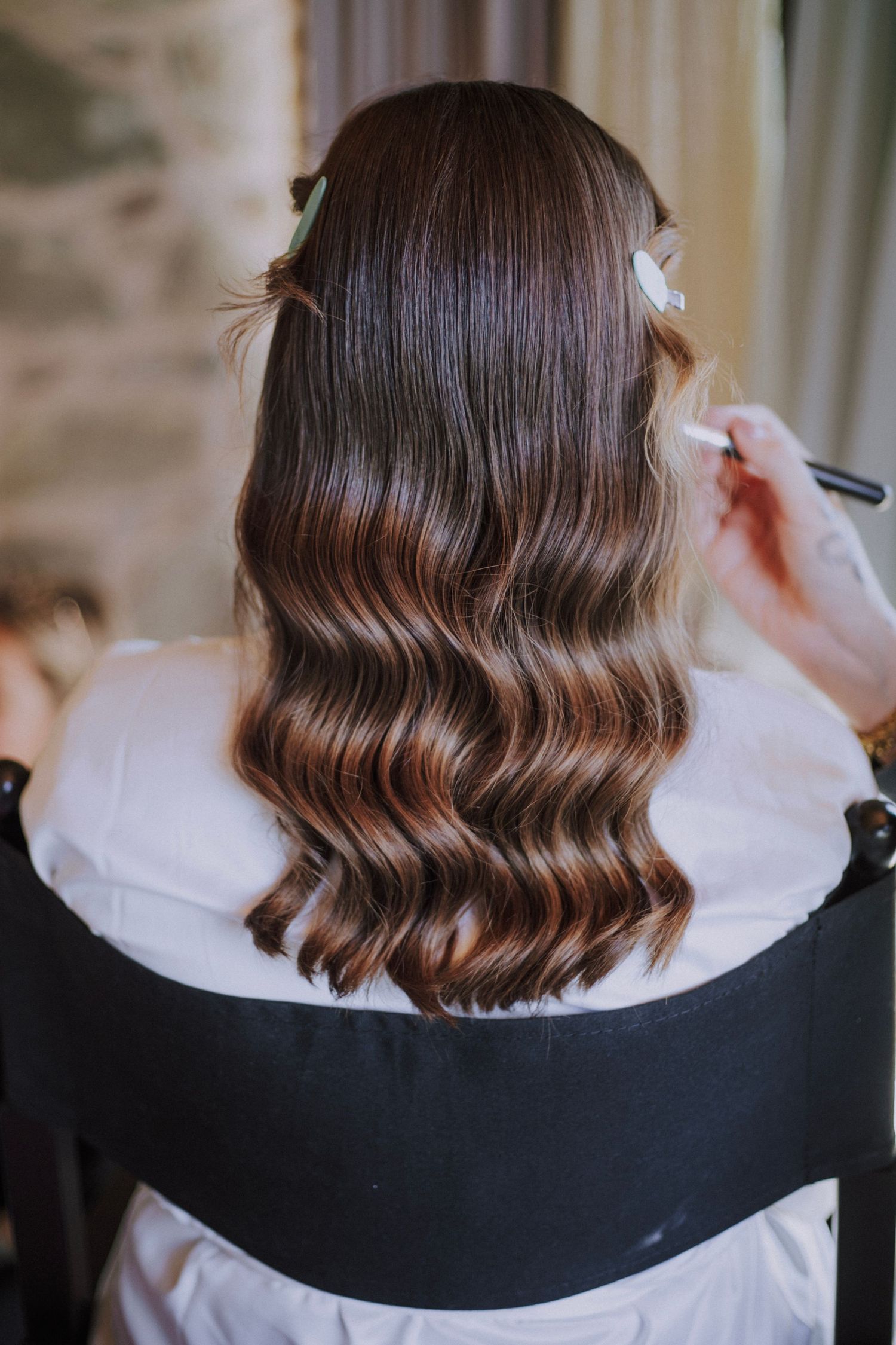 Bride's hairstyle during her preparation at Perugia Vecchia Relais pictured by Gianluca e Arianna Wedding Photographers in Umbria, Italy.