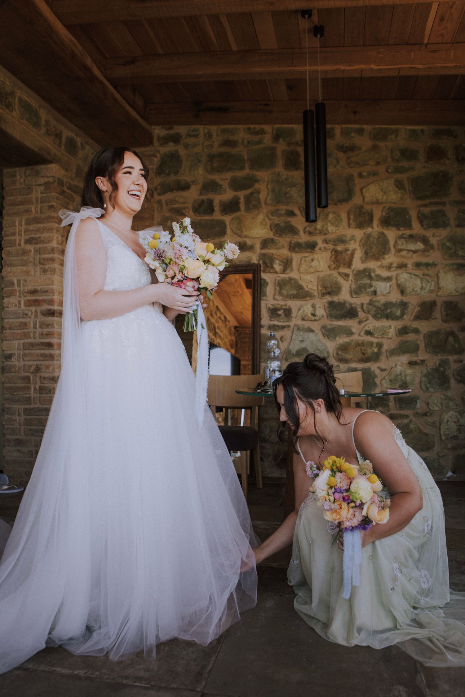 Bride smiling while she gets dressed at Perugia Vecchia Relais photographed by Gianluca e Arianna Wedding Photographers in Umbria, Italy.