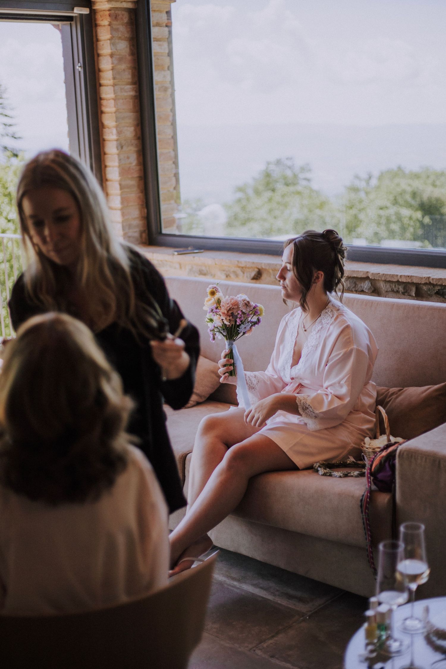 Bridesmaid enjoying scent of flowers at   Perugia Vecchia Relais photographed by Gianluca e Arianna Wedding Photographers in Umbria.