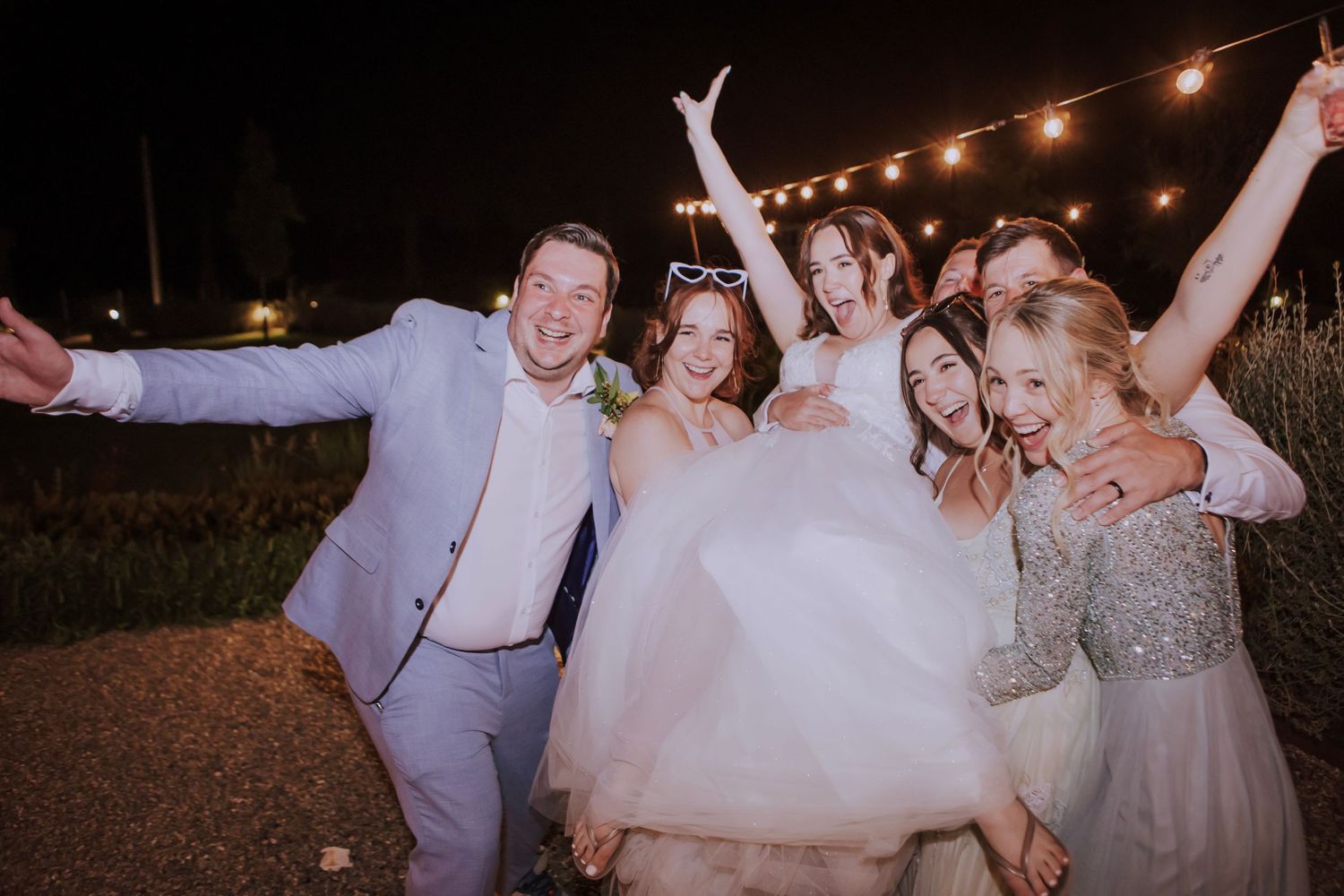 bride picked up by friends during wedding party photographed by Gianluca e Arianna Wedding Photographers in Umbria