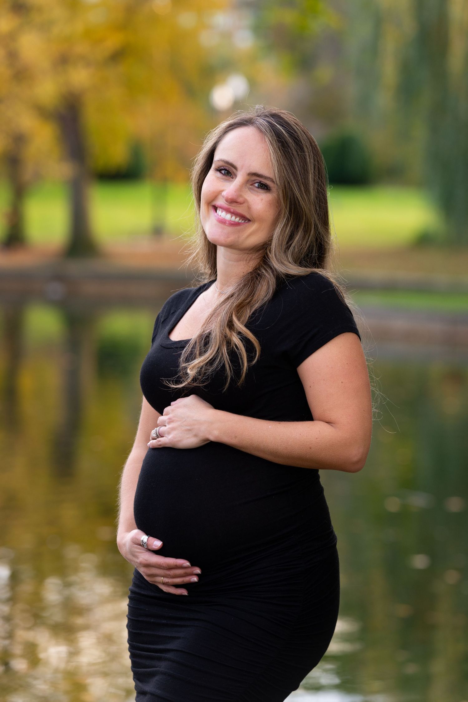 Fall Foliage woman in a black dress Maternity Portraits in the Boston Public Garden with Leah Ramuglia Photography