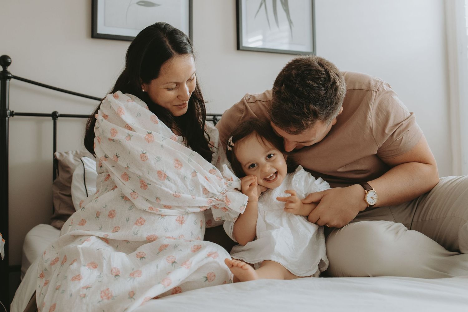 Family sharing joyful moments together on a cozy bed.
