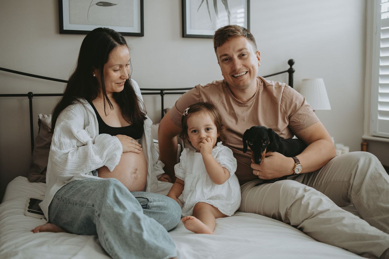 Candid family moments captured in a series of relaxed bedroom photos.