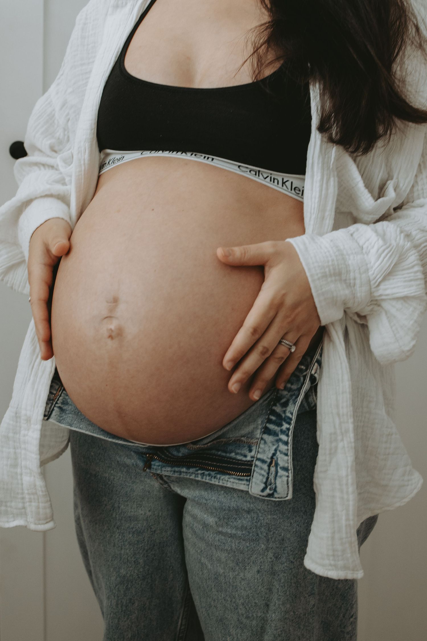 Series of maternity photos showing growing baby bump in casual attire.