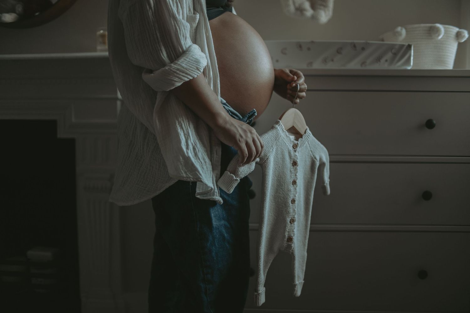 Moody lifestyle photography session showing nursery details in dim lighting.
