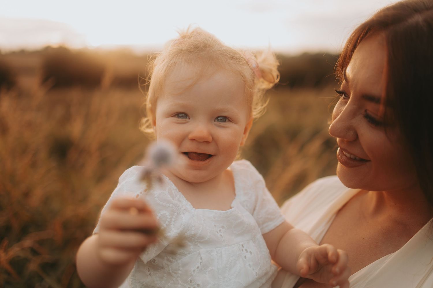 A joyful moment captured in golden sunlight during a family photoshoot.