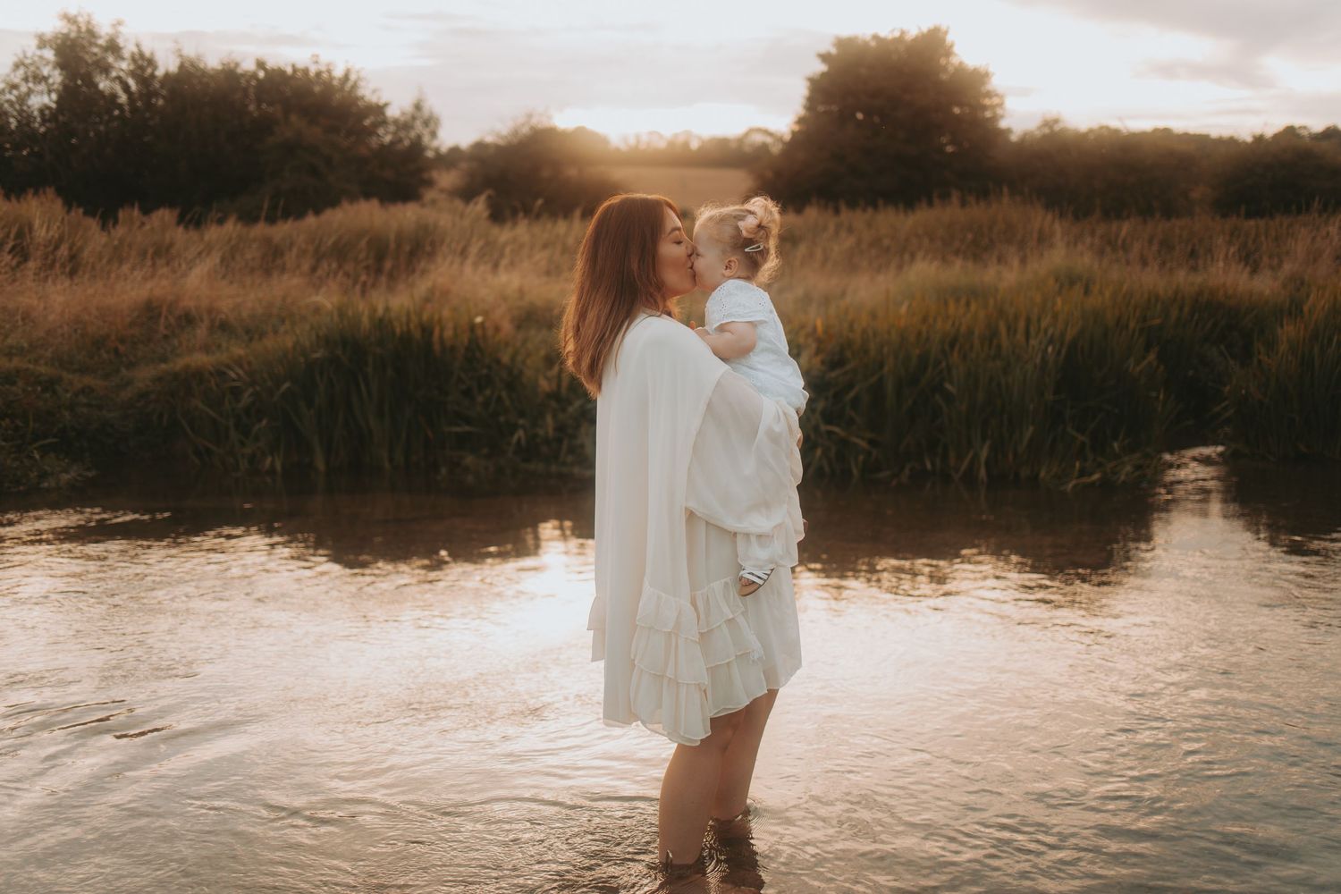 Serene water photography session at golden hour with natural landscape elements.