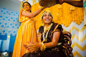 Joyful celebration during Indian wedding ceremony with bride wearing traditional attire.
