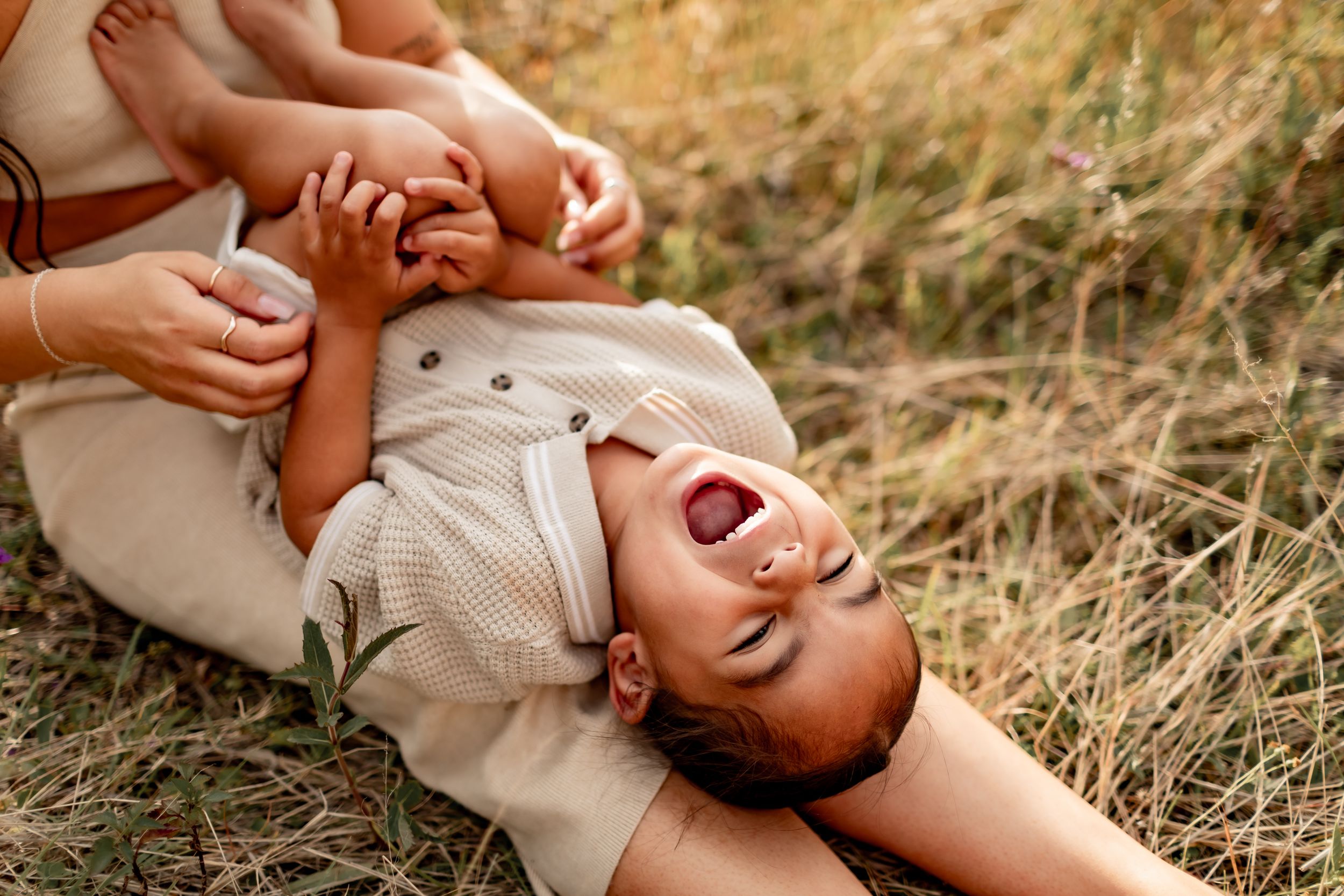 Joyful playtime captured in a natural outdoor setting with golden sunlight.
