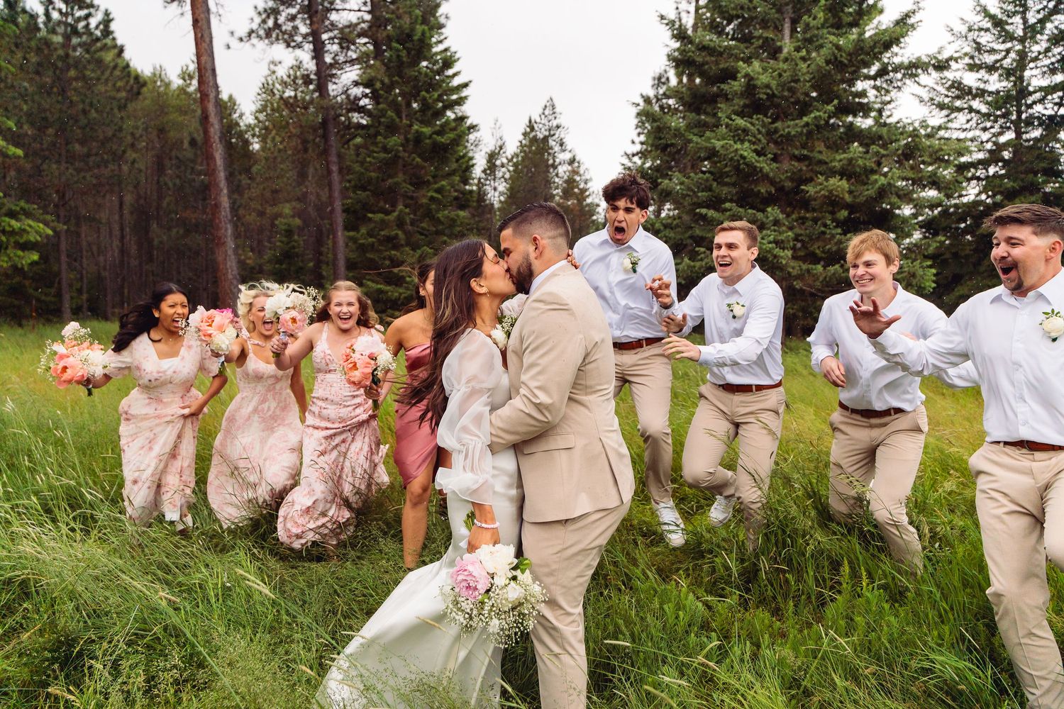The bride and groom walk hand in hand along a scenic mountain trail, marking their intimate elopement in Montana.