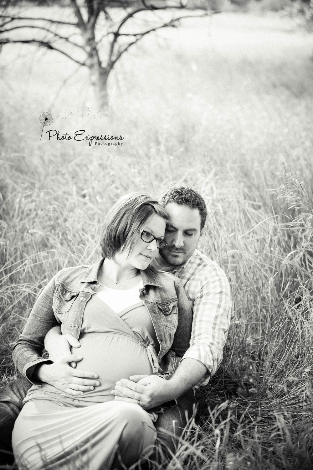 Black and white intimate portrait session in a meadow setting.