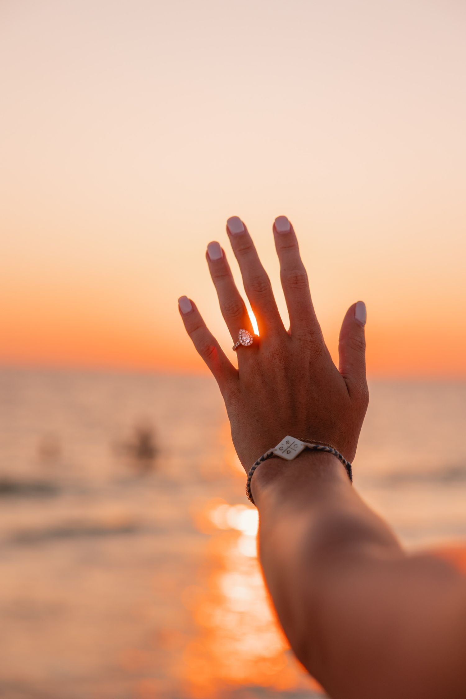 engagement detail shot of a ring at sunset on the wrightsville beach coast