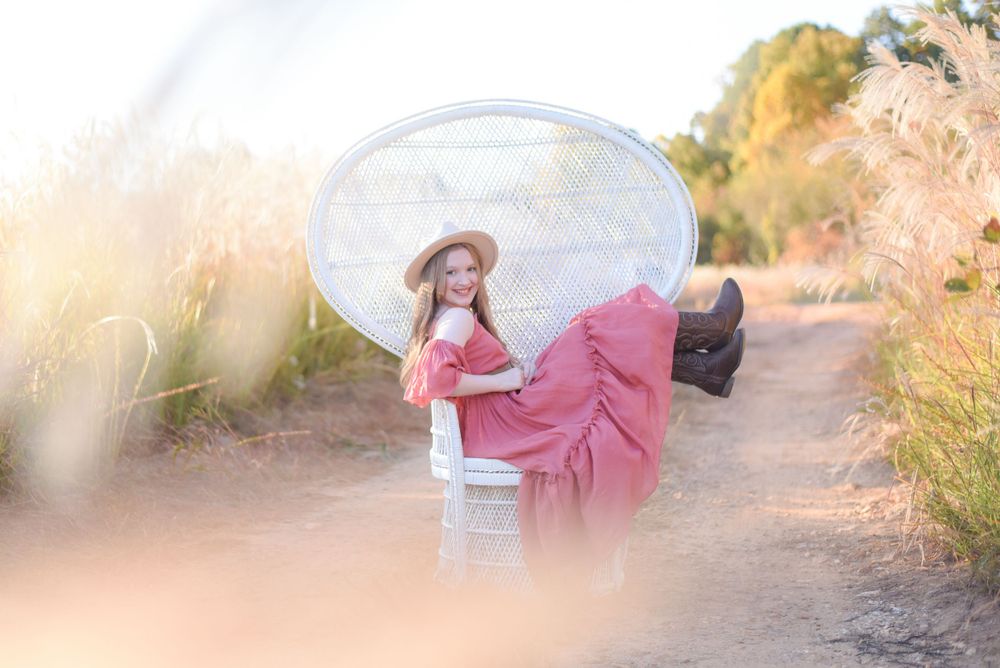 Dreamy outdoor portrait session with pink dress and reflector in golden sunlight.