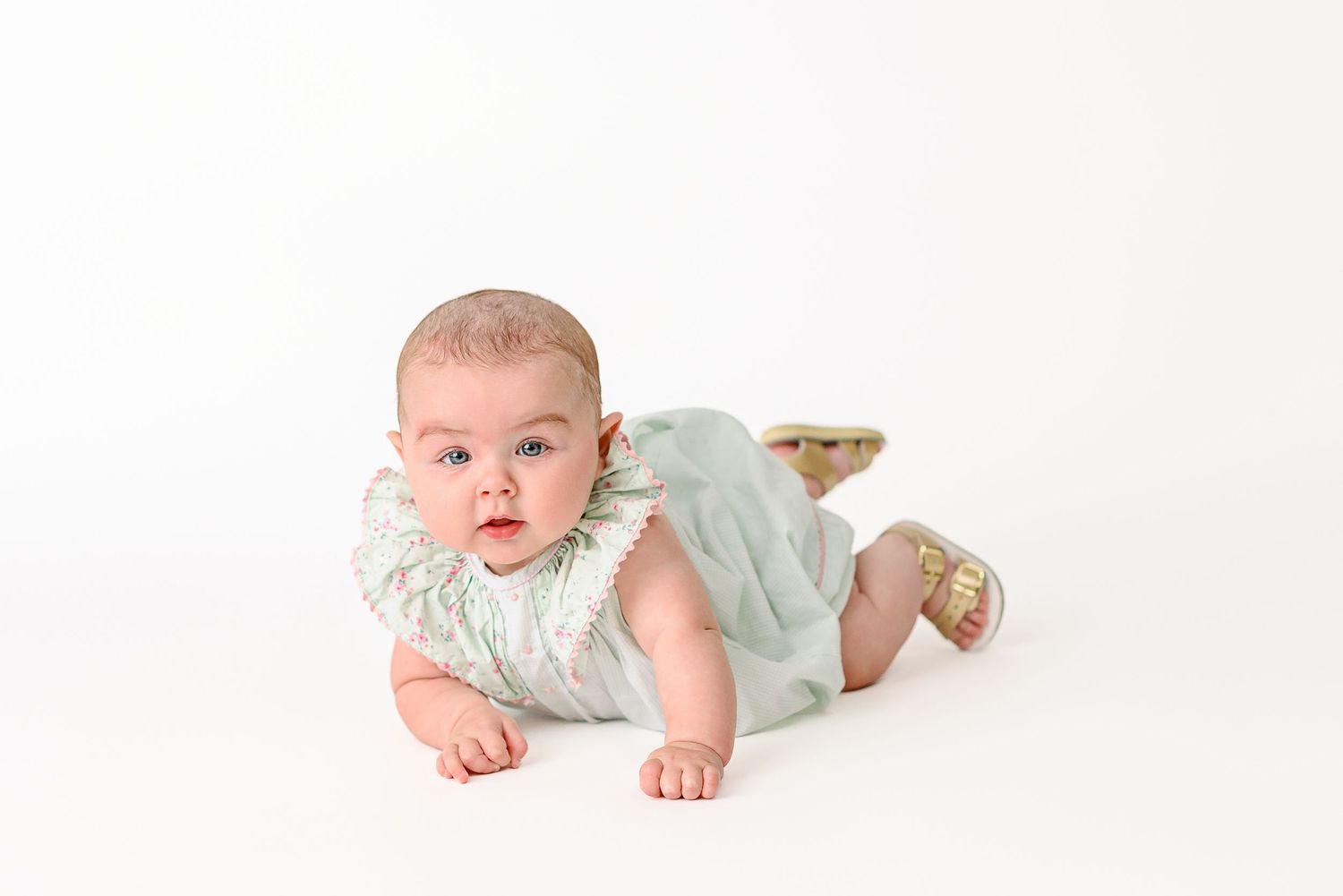 baby milestone portrait in a crawling position
