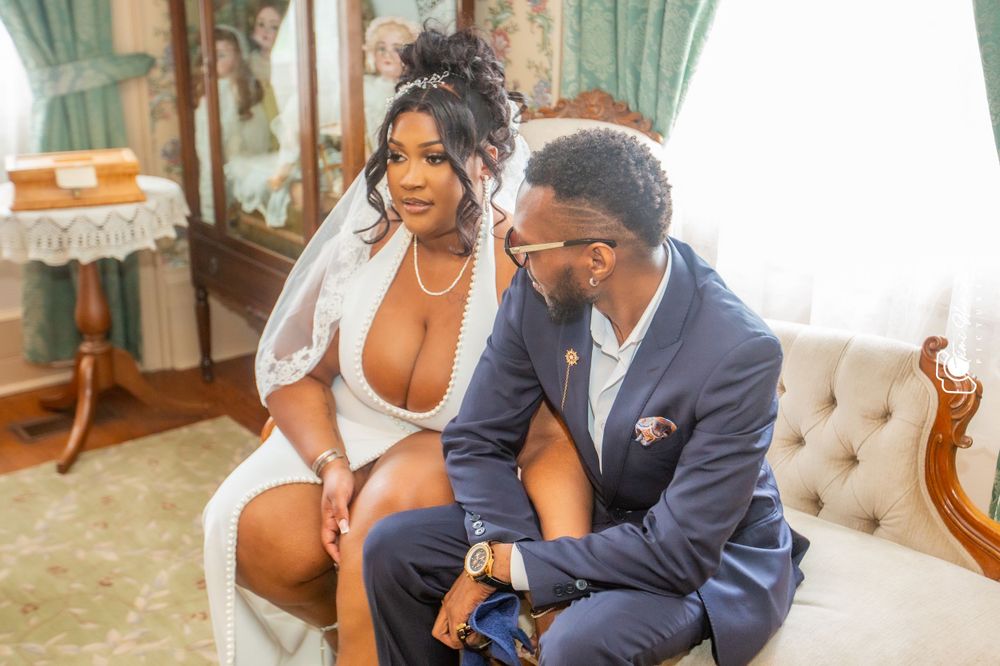 Intimate portrait of couple in formal wear seated on classic furniture.