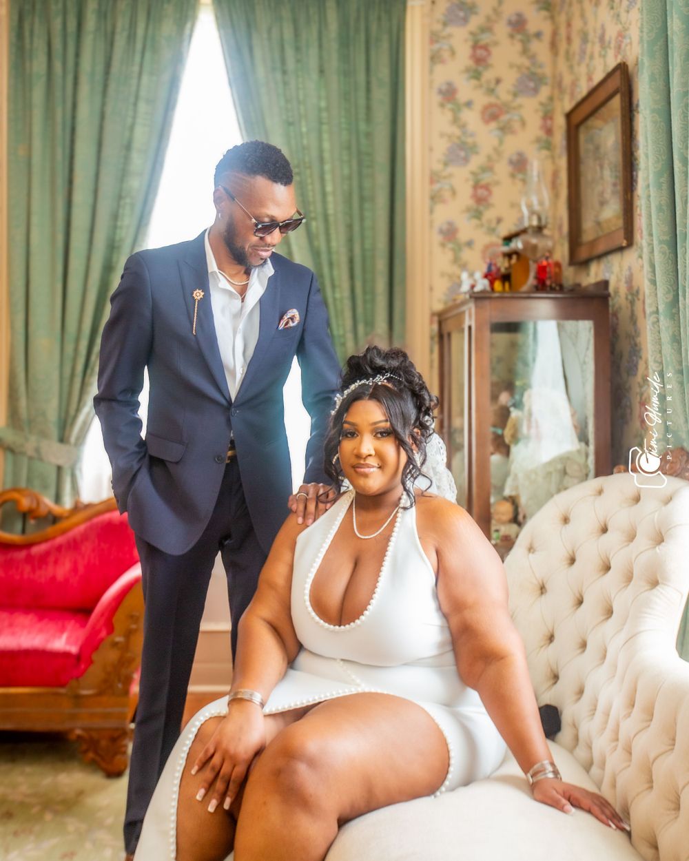 Glamorous couple photo session with elegant furniture and decor.