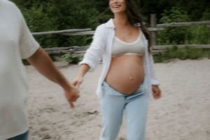 Candid beach moment with people in light denim and white clothing.