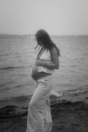 Moody black and white maternity photos by the ocean.