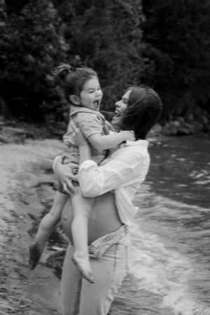 Joyful beach moment captured in black and white with splashing water.