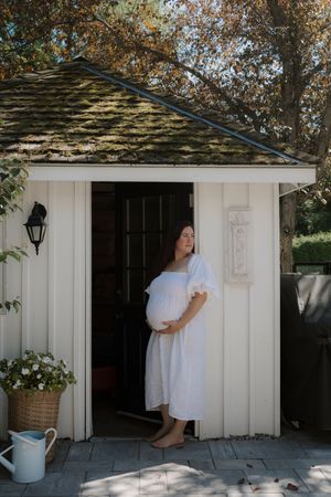 A series of images showing someone in a white dress standing near a rustic white shed or garage door.