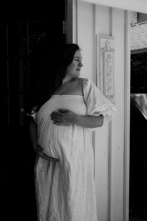 Black and white photos showing a figure in white linen dress against a white wall.