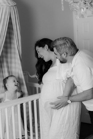 A series of tender moments captured in black and white by a white crib.