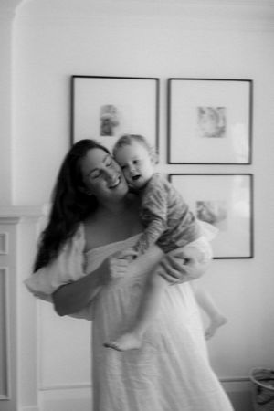 Joyful indoor playtime moments with baby in bright white room.