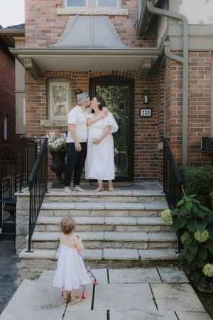 Candid family photos on brick porch steps showing loving interactions.