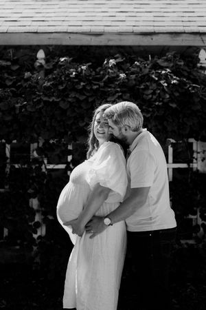 Black and white photo series capturing intimate family moments outdoors.