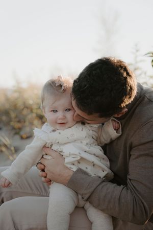 Sweet candid moments between family members on a bright winter day.