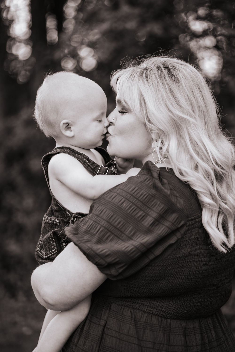Sweet black and white portrait of tender mother-baby moment.