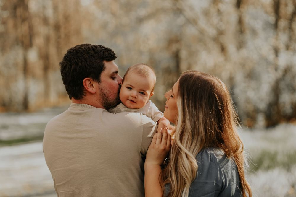Intimate family moment captured during outdoor photo session.