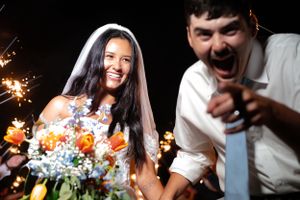 Nighttime celebration with sparklers creating light trails against dark background.