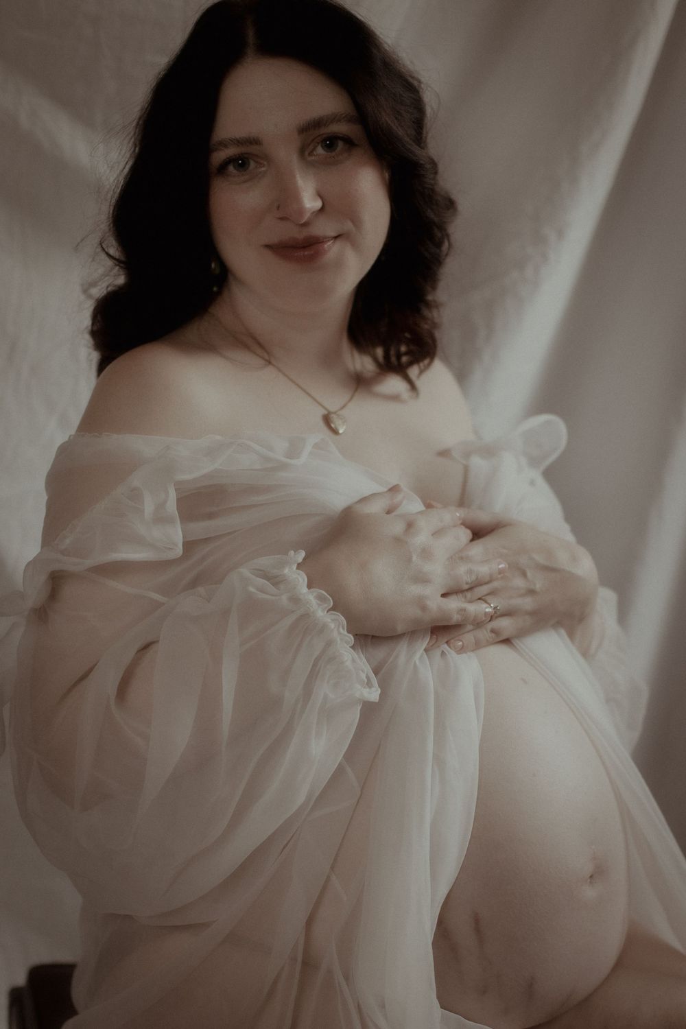 PNW Maternity Photographer
A dreamy maternity portrait features a woman in flowing white fabric against a light backdrop.
Film Photographe