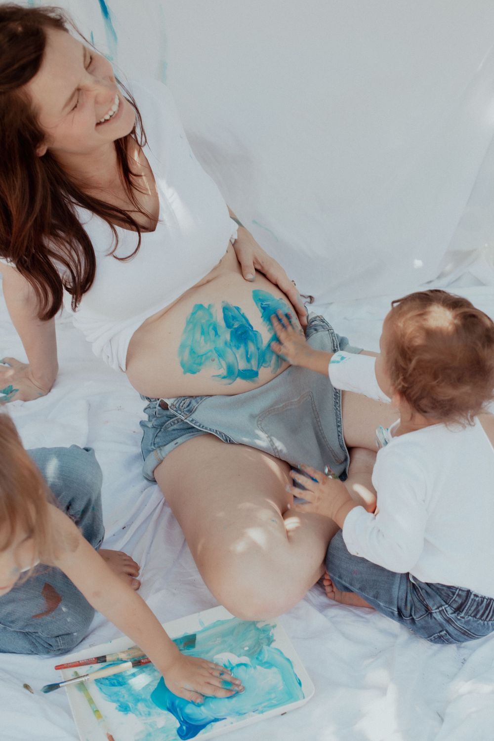 PNW Maternity Photographer
PNW Family Photographer
Creative pregnancy photoshoot with blue paint and white backdrop.