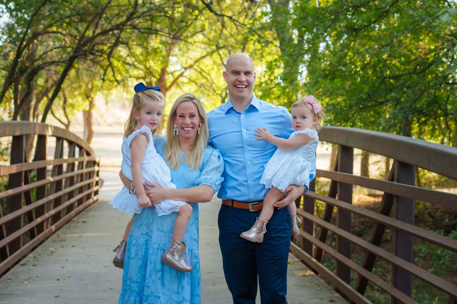 maternity photo session fall family mini baby boy expecting mom big sisters blue dress and blue eyes boots outdoors Keller TX wooden bridge