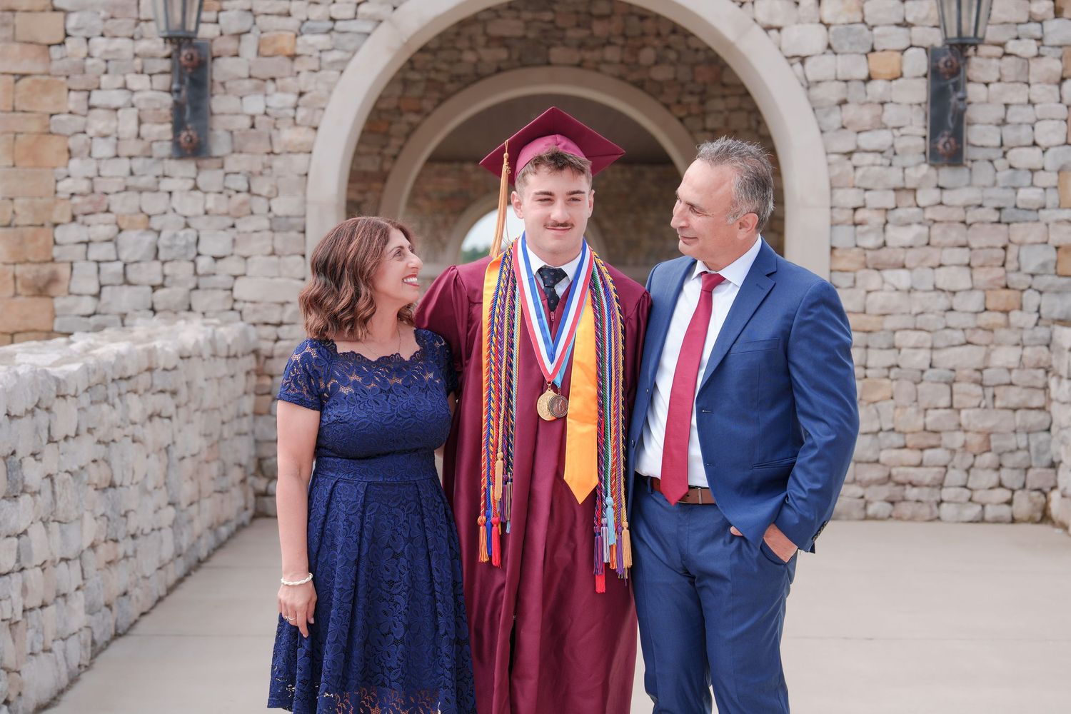 extended family photos Westlake Texas graduation day dress up cap and gown parents and grandparents celebrate milestone Westlake Acadamy