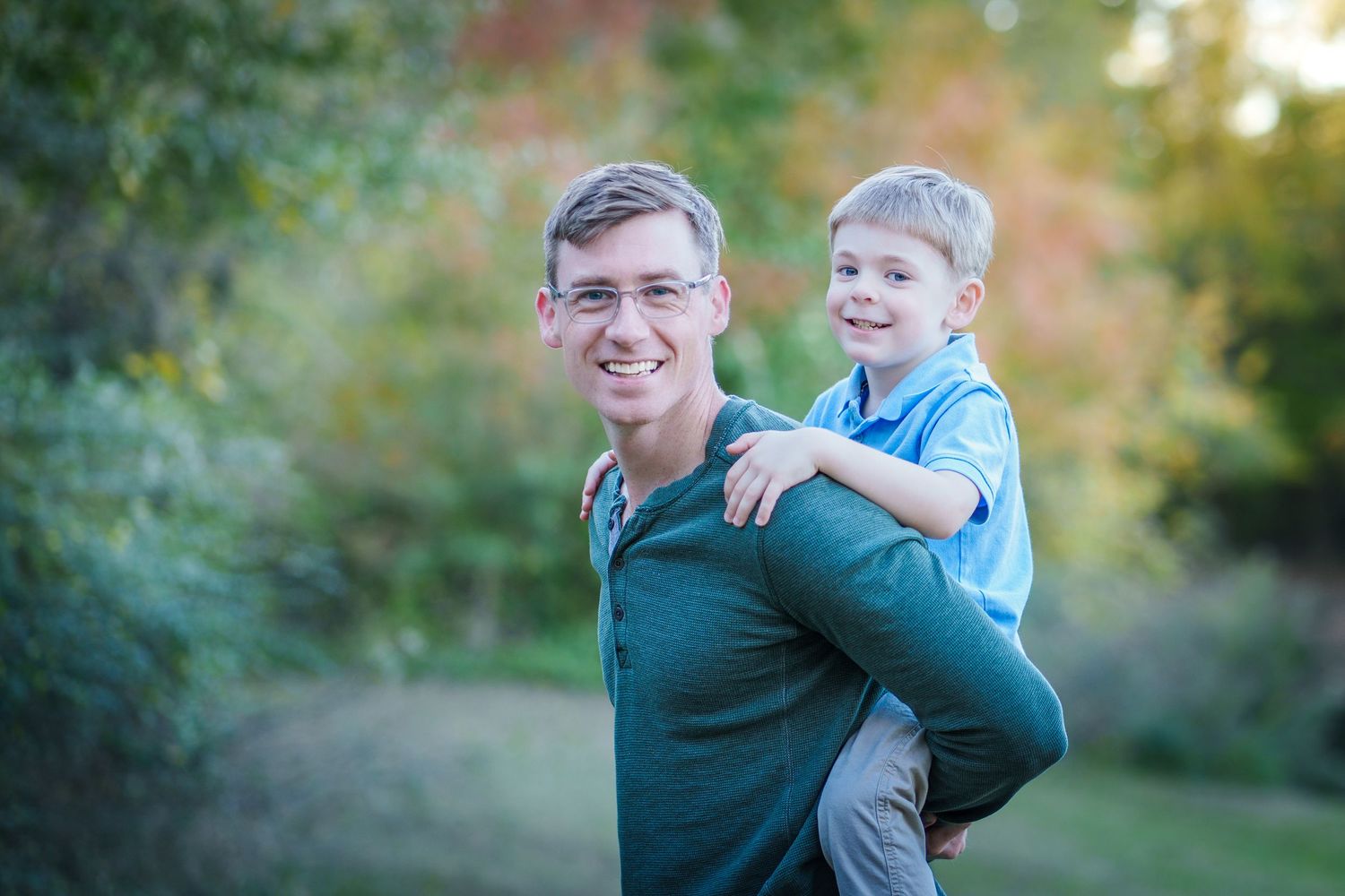 fall family session mini dad throwing son in air playful good times love fun orange colors outdoors sunset golden hour pose prompted sweet