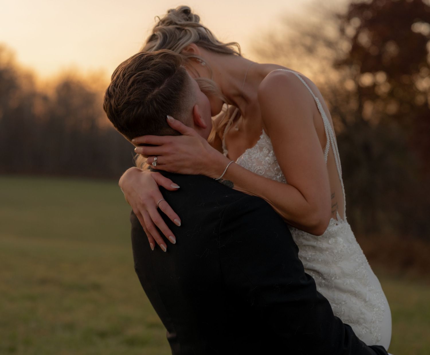A joyful wedding ceremony moment with a couple and officiant indoors.