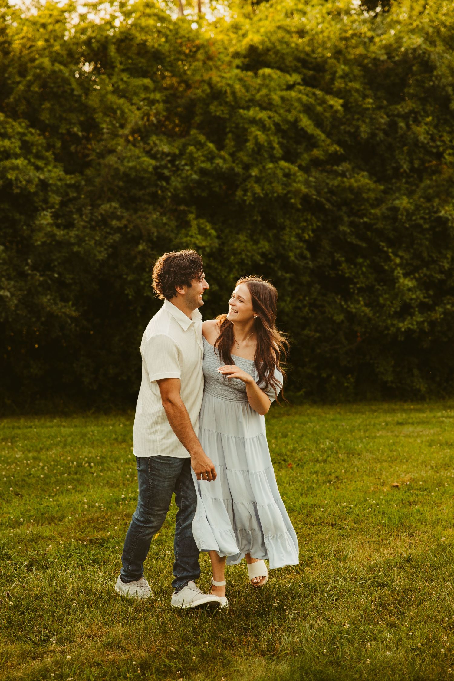 Metro Detroit couple laughs and walks together through a park