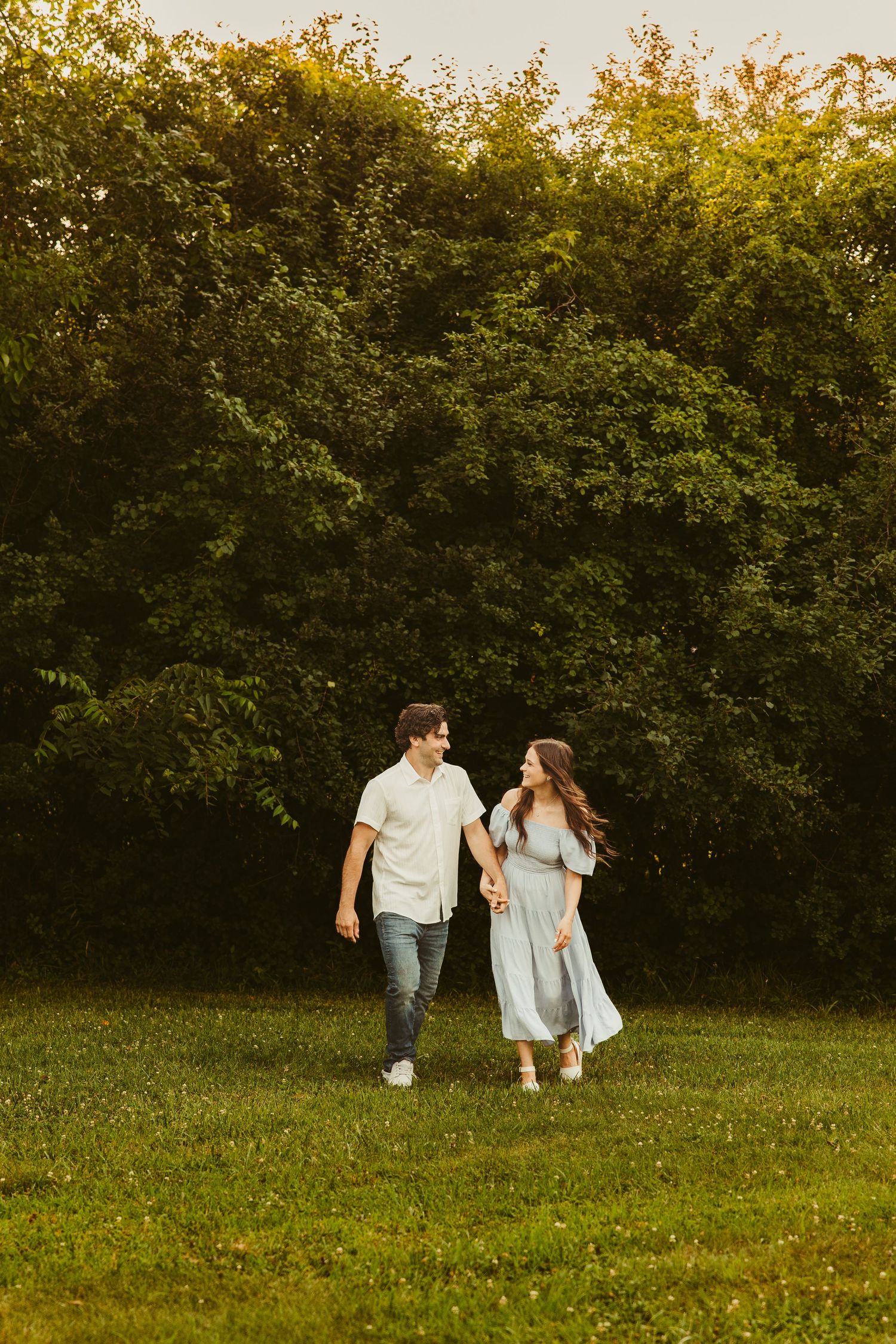 Metro Detroit couple's session showing couple walk through a park holding hands