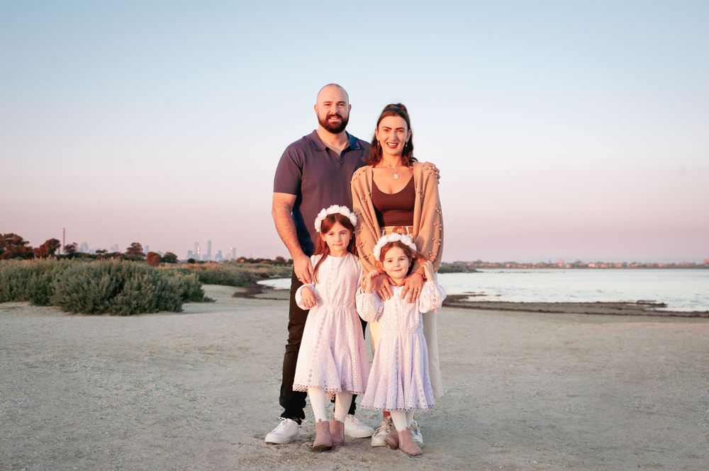 Family portrait on a beach at sunset with pastel sky and water in the background.
Altona Family Photographer Melbourne