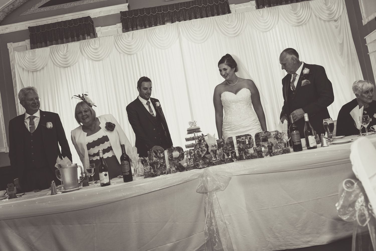 black country wedding affair, with the bride and groom along with parents sittiing at the top table