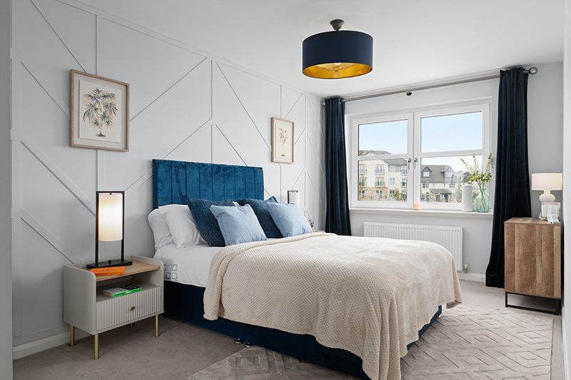 Modern bedroom interior with white walls, navy blue accents, and minimalist furniture features clean lines and natural light.
