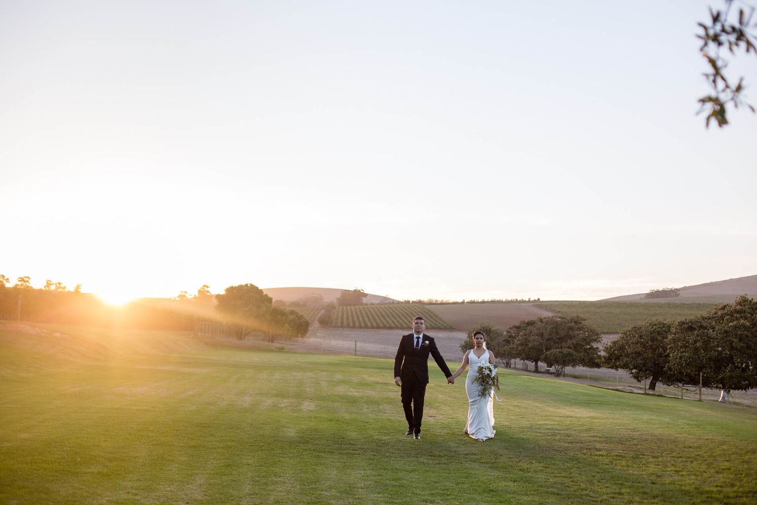 bride and groom romantic moment walking during sunset (Wedding couple photoshoot by Lesley Marks)