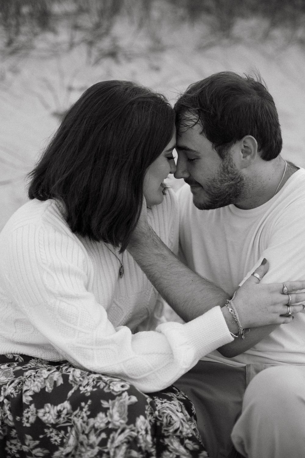Romantic black and white photo sequence showing a couple sharing tender moments together.