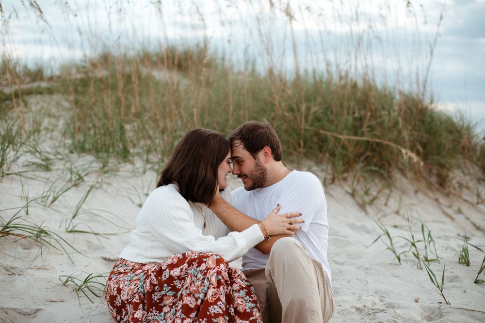Romantic beach photoshoot sequence with couple among coastal dunes and grass.