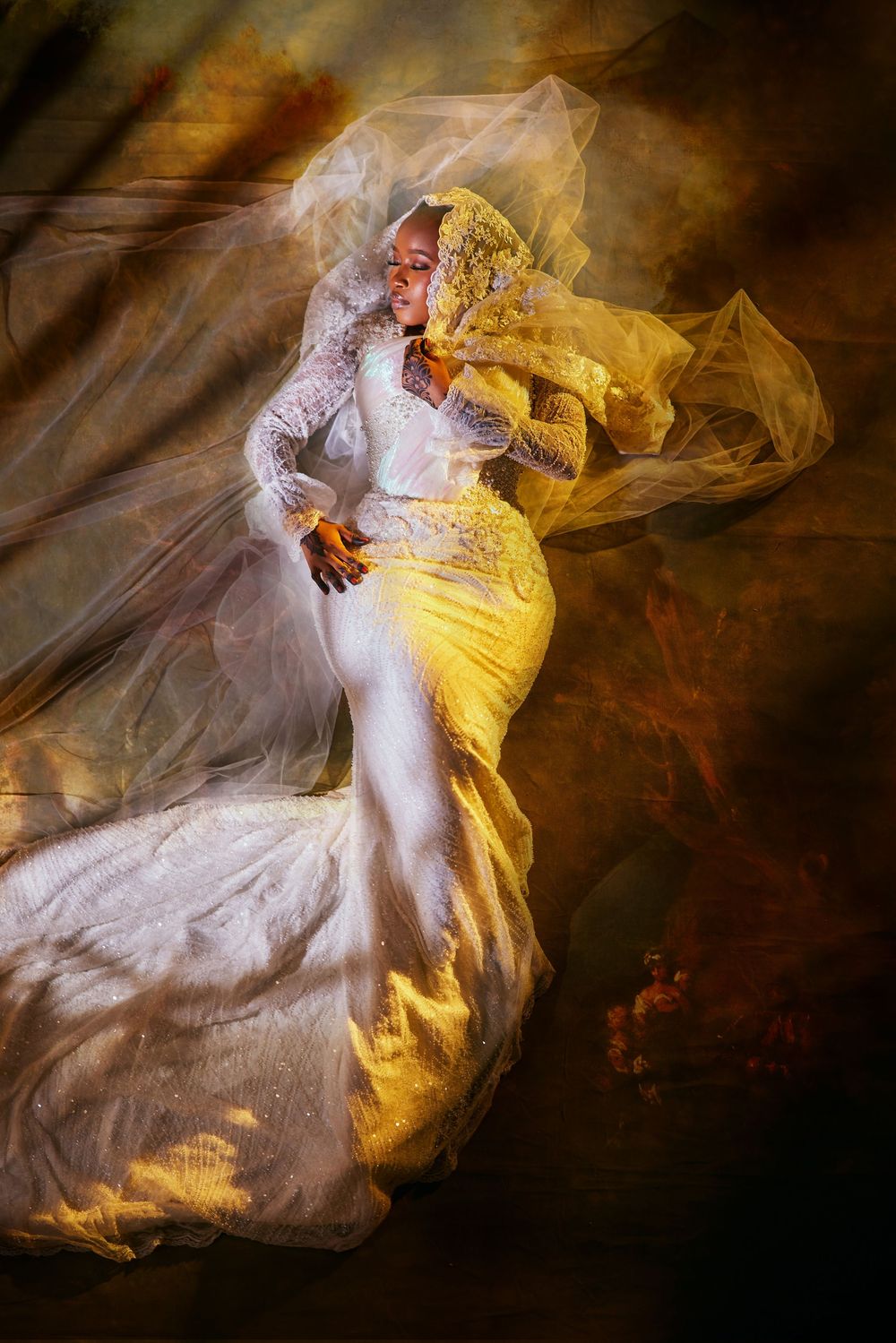 Ethereal bridal portraits with flowing fabric and dramatic yellow lighting effects.