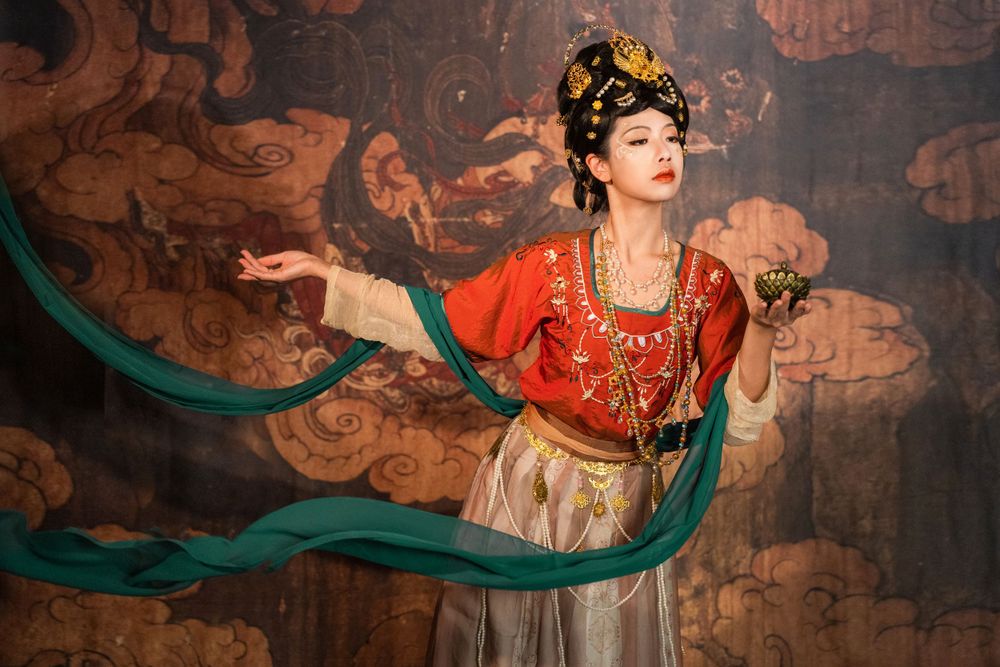 Divine studio photography of Dunhuang Apsaras Hanfu styling with cinematic lighting and mural backdrop, by Imagine Image Studio.